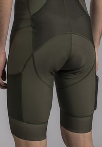 Olive green compression shorts with a smooth texture, featuring reinforced seams, a padded rear section, and a fitted design.