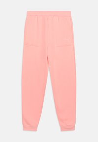 Pantaloni della tuta rosa con vestibilità rilassata, dotati di due tasche frontali e polsini elastici alle caviglie. Logo Puma bianco sulla tasca sinistra.