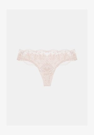 Lace thong in light pink, featuring floral patterns, scalloped edges, and sheer texture. Elastic waistband and minimal back coverage.