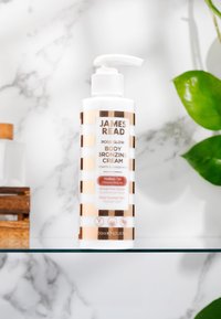 James Read Rose Glow Body Bronzing Cream in a white and rose gold striped bottle with pump, 200ml, labeled "Medium Tan," vegan, rose scent.