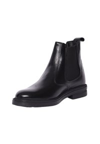 Stivale Chelsea in pelle nera con pannelli elastici laterali, punta rotonda, tacco basso e una texture liscia; progettato per facilità di utilizzo.