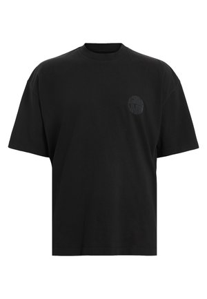 Camiseta de algodón negra con un corte holgado, mangas cortas y escote redondo. Presenta un sutil logotipo tonal en el lado izquierdo del pecho.