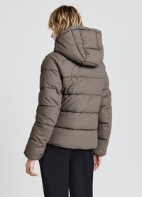 Puffer jacket in olive green, featuring a hood, ribbed cuffs, and quilted design with stitched horizontal patterns. Zippered side pockets.