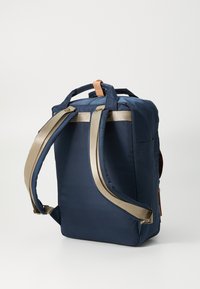 Navy backpack with gold straps and a brown leather accent. Features two adjustable straps, a rectangular shape, and a smooth texture.