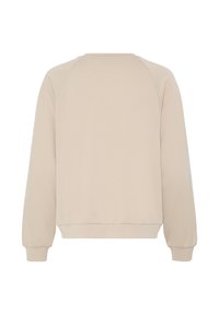 Bēšs sporta krekls ar mīkstu tekstūru, raglāna piedurknēm un ribveida apakšmali. Dizains ir vienkāršs un tīrs, bez rotājumiem aizmugurē.