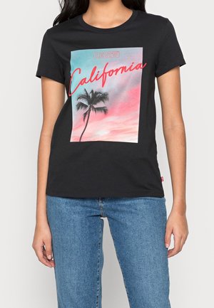 Black cotton t-shirt featuring a front graphic with a palm tree and pastel sky, labeled "California" in bold red script. Short sleeves, crew neck.