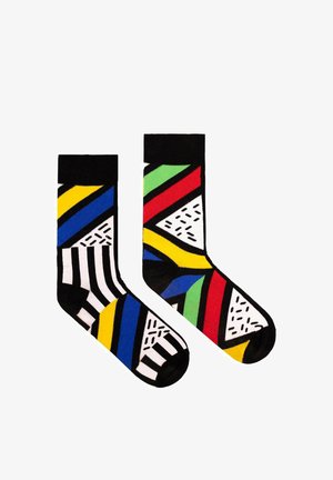 Kolorowe skarpetki bawełniane z geometrycznymi wzorami; jedna strona ma paski i wyraziste kolory, podczas gdy druga prezentuje kąty i akcenty teksturowe.