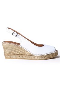 Valkoinen avokas espadrilles-kengät, joissa on avonainen kärki, kudottu juutti-pohjallinen ja brodeerattu yksityiskohta. Säädettävä hihna metallisoljella.