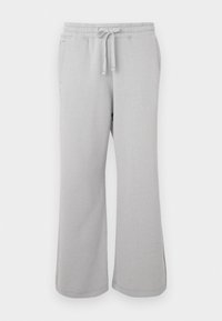 Lysegrå sweatpants lavet af blødt materiale, med bred ben-udformning, elastisk talje med snor og sidelommer.