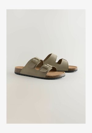 Par de sandalias deslizables de color verde oliva con dos correas ajustables con hebillas y una plantilla de textura de corcho sobre un fondo claro.