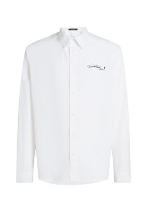 White long-sleeve button-up shirt made of cotton with a pointed collar and black embroidered logo on the left chest. Smooth texture.