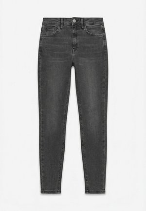 Melni augsta vidukļa pieguloši džinsi ar priekšējām un aizmugurējām kabatām, pogu aizdares un smalkām izbalinātām detaļām gar kājām.