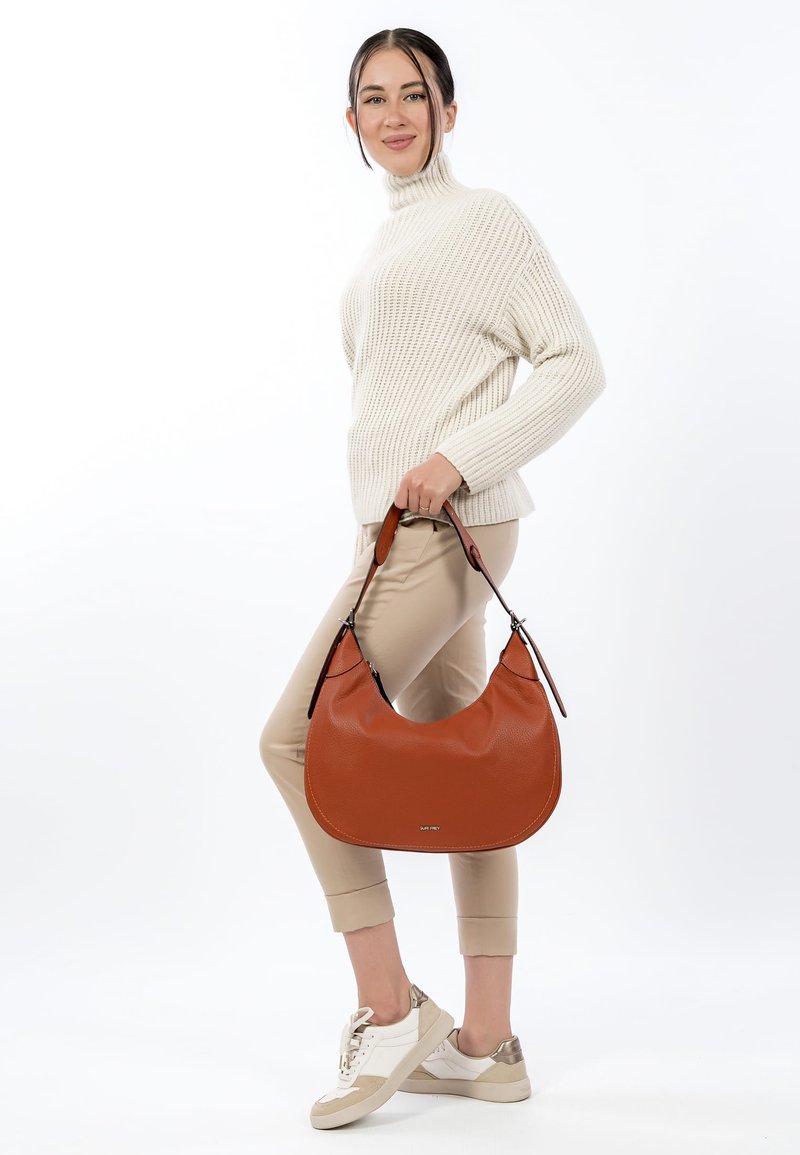 Hobo handbag in textured rust-colored leather, featuring a curved shape, two adjustable straps, and silver-tone hardware accents.