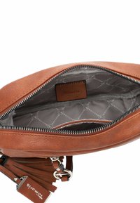 Brown leather handbag with a smooth exterior, zip closure, and grey interior lining featuring repeating geometric patterns.