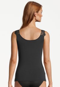 Black sleeveless tank top with lace accents on the shoulder straps, featuring a fitted design and smooth texture. Back view shown.