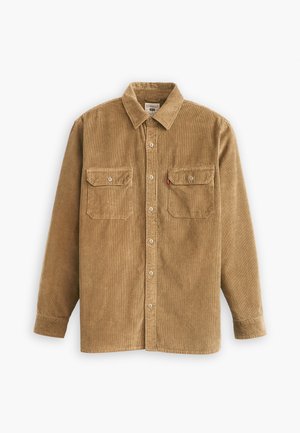 Corduroy shirt in light brown with a collared neck, button closure, and two chest pockets. Features textured fabric and long sleeves.