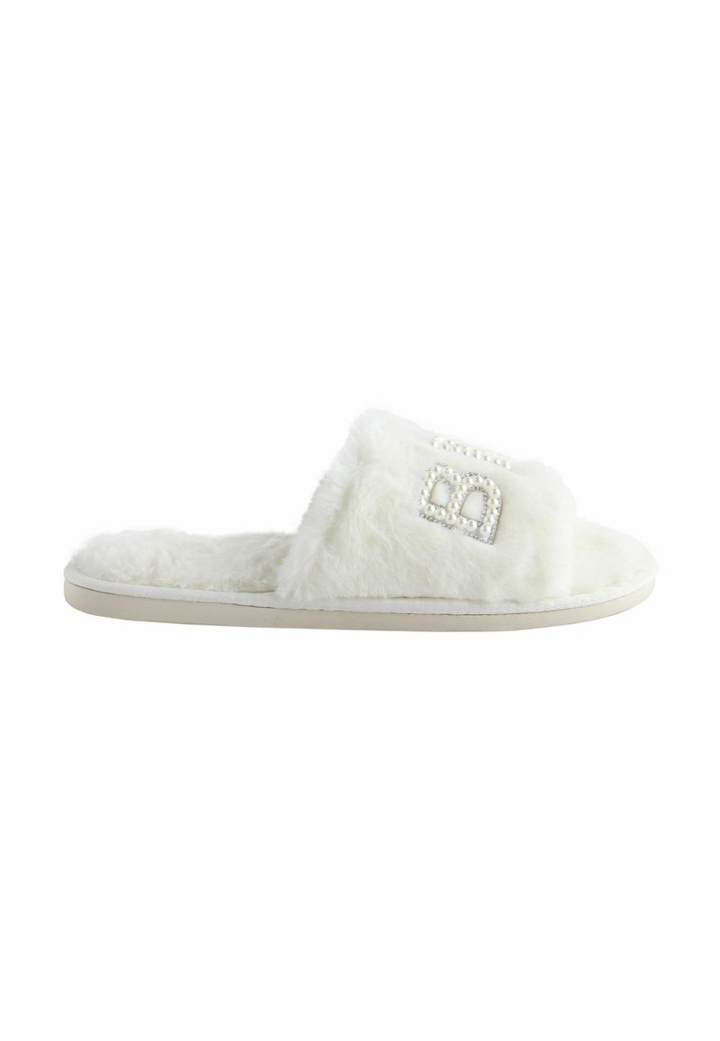 White fuzzy slide slippers with a thick sole, featuring a decorative element of small faux pearls and an outlined logo. Soft texture.