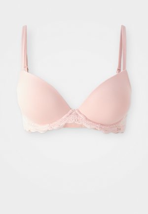 Light pink padded bra with lace trim at the base. Adjustable straps and smooth cups, providing a seamless look and gentle support.