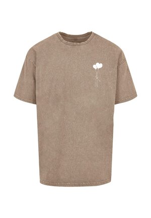 Tricou din bumbac maro cu o croială relaxată, decolteu rotund și mâneci scurte. Are un mic grafic alb reprezentând o figură care ține baloane.