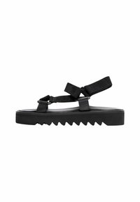 Crne sandale s debelim potplatom sa uzorkom cik-cak, podesivim trakama i glatkim gornjim materijalom. Uključuju čičak trake.