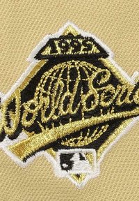 Gold and black embroidered patch featuring a globe design and "World Series" text on a tan fabric background. Includes 1993 date detail.