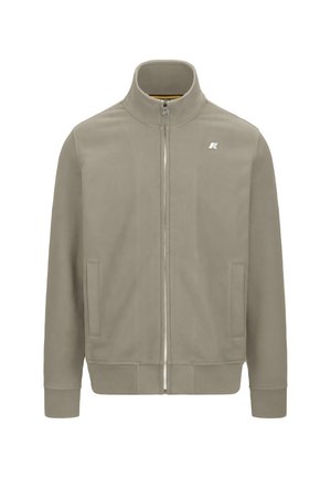 Giacca zip-up grigia chiara con colletto alto, polsini a coste, due tasche frontali e un piccolo logo sul lato sinistro del petto. Tessuto liscio.