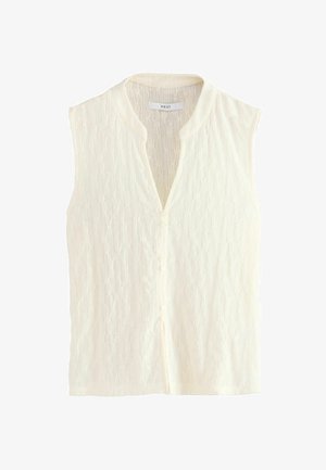 Blouse sans manches à boutons à l'avant en crème avec un motif en dentelle texturée et un décolleté en V peu profond. Tissu doux avec des détails subtils.
