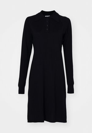 Czarna sukienka polo z długim rękawem, wykonana z miękkiego materiału, z kołnierzykiem, listwą guzikową i ściągaczami przy mankietach, o prostym kroju.