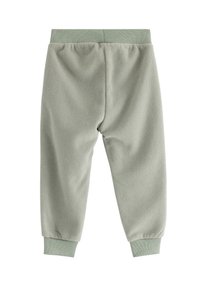 Fleecebyxor i ljusgrön med ribbad midja och fotledsmuddar. Mjuk textur med en enkel, oanvänd design.