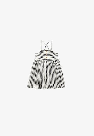 Robe sans manches rayée blanche et bleu marine pour enfant avec fines bretelles croisées et trois boutons en bois sur le corsage avant.