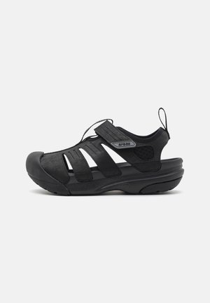 Black sandals with synthetic upper, open design, adjustable straps, padded collar, rubber toe cap, and textured sole for grip.