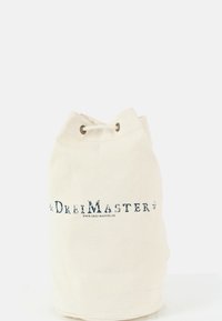 Plátěná taška na rameno v krémové barvě, vybavená stahovací šňůrkou, kovovými oky a potiskem loga v námořnicky modré barvě.