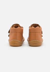 Teddy leer peuterschoentjes met een zachte, textuurafwerking, golvende randen en een rubberen zool. Voorzien van verstelbare klittenbandstrappen.