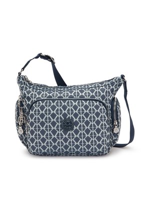 Navy blue crossbody bag with a geometric white pattern, adjustable strap, front zip pocket, and decorative charm. Soft, durable fabric.