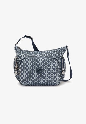 Navyblaue Umhängetasche mit einem geometrischen weißen Muster, verstellbarem Riemen, einer vorderen Reißverschlusstasche und einem dekorativen Anhänger. Weicher, strapazierfähiger Stoff.