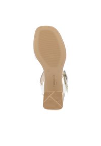 Heeled sandal with a beige rubber sole, white straps, and a textured accent. Features a side buckle for secure fastening. Size 37.