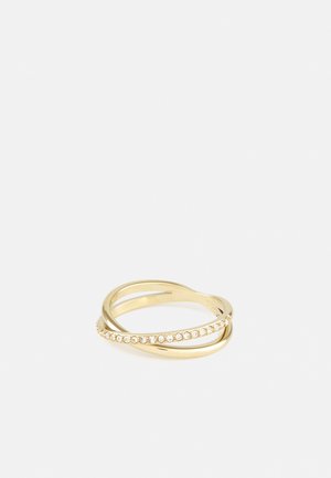 Gold ring with two intersecting bands, one plain and one studded with small clear crystals, on a white background.