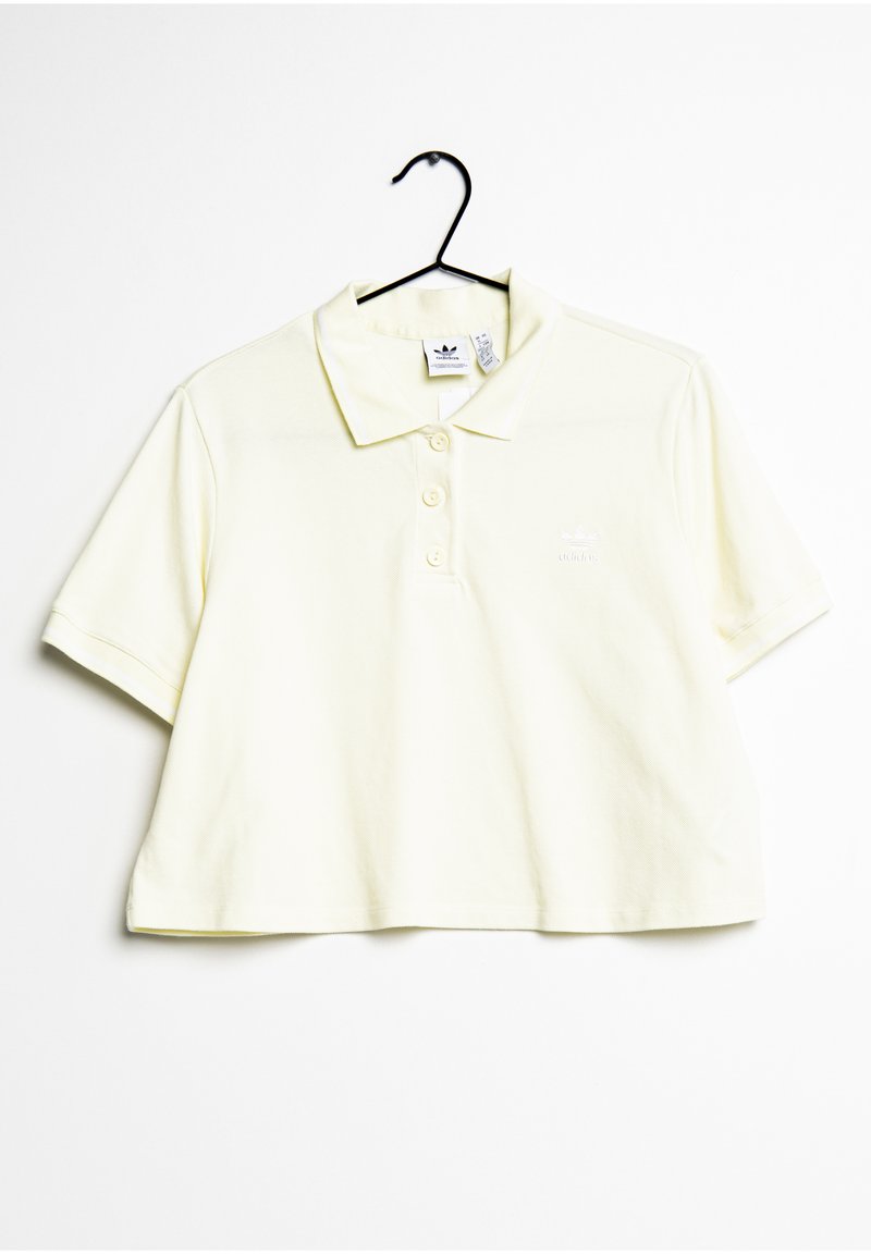 Polo shirt jaune coupé en coton doux, avec une patte de boutonnage à trois boutons et un logo blanc sur la poitrine gauche. Manches courtes.