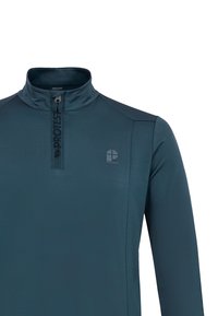 Tmavý petrolejový športový top s dlhým rukávom, polovičným zipsom, vysokým golierom a malým logom značky na ľavej strane hrudníka.
