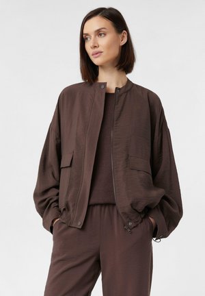 Brown bomber jacket with a smooth, slightly textured finish, featuring a zip closure, side pockets, and a relaxed silhouette.