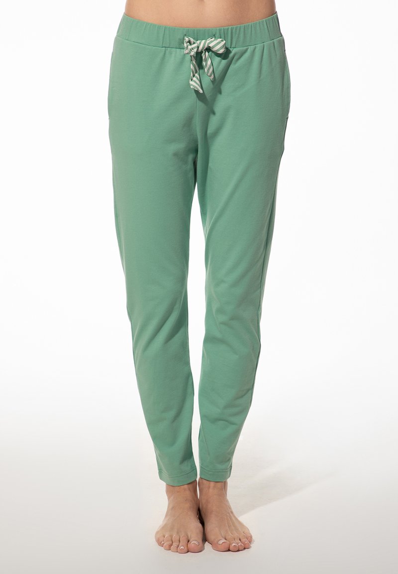 Groene katoenen joggerbroeken met een elastische tailleband en een gestreepte trekkoord. De pijpen zijn taps toelopend en er zijn zijzakken.