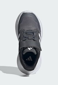 Dark gray athletic shoe featuring a breathable mesh upper, padded tongue, dual strap, and white accents on the sole and sides.