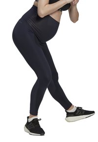 Leggings da maternità neri con vita alta e texture liscia. Presentano lunghezza alla caviglia e sottili dettagli in rete per traspirabilità.