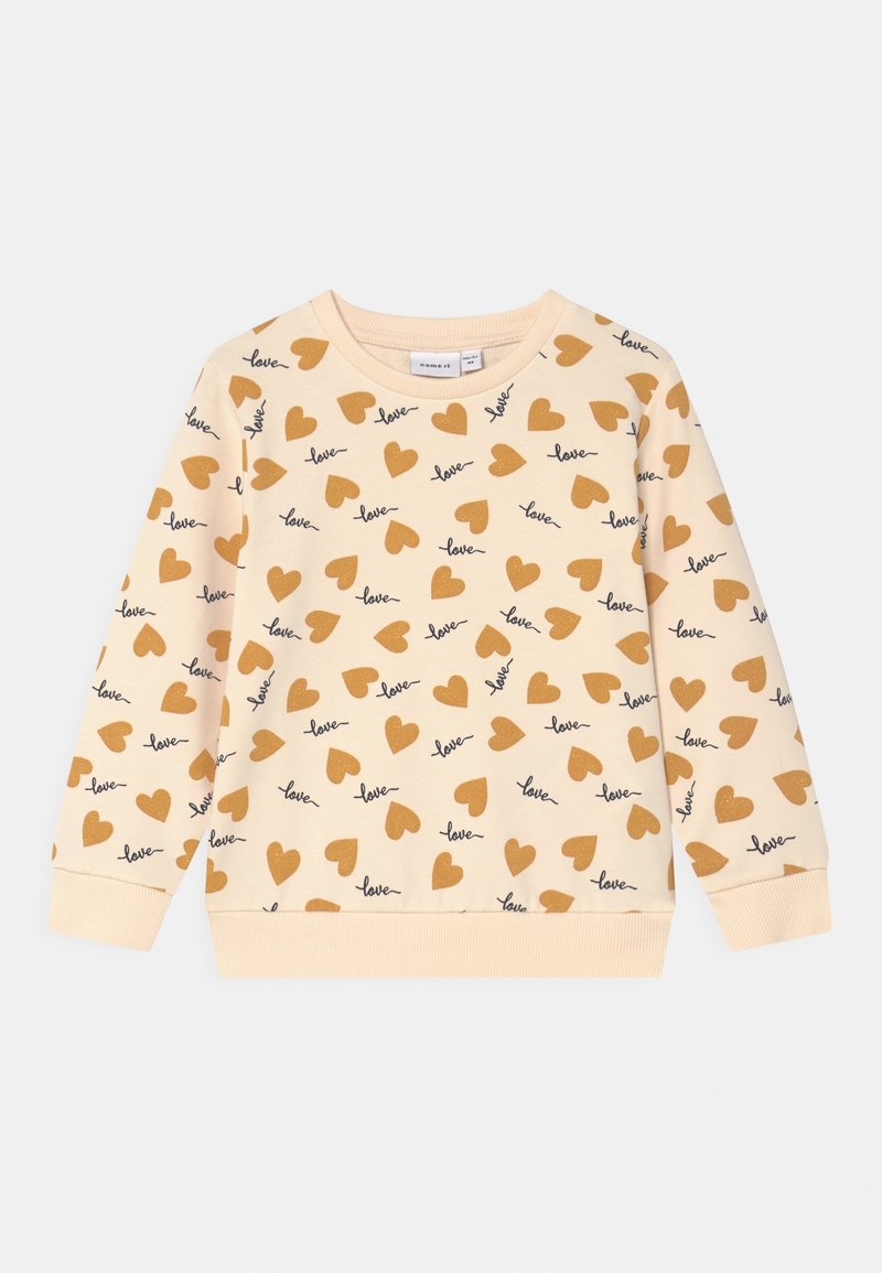 Sweat-shirt pour enfants à manches longues de couleur crème, orné de cœurs marron et du mot "love" écrit en écriture cursive noire sur tout le tissu.