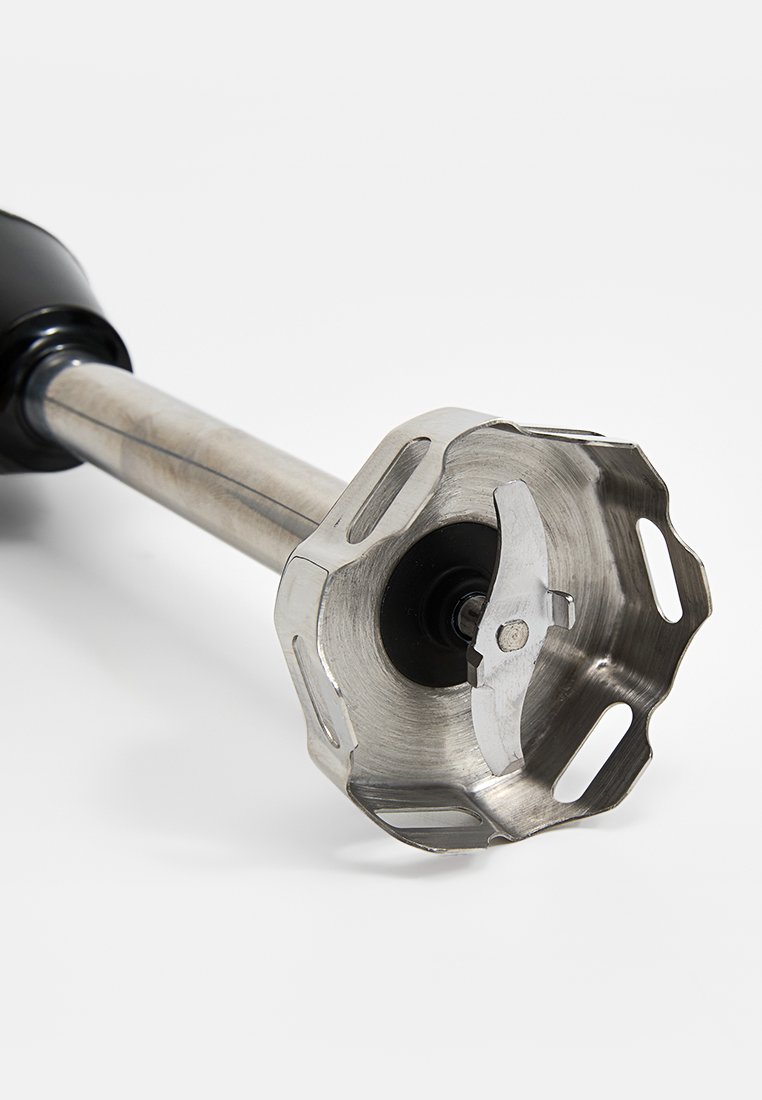 Nasadka do blendera ręcznego z ostrzem blendującym ze stali nierdzewnej, cylindrycznym metalowym wałem i czarną plastikową rączką. Posiada wycięcia w podstawie.