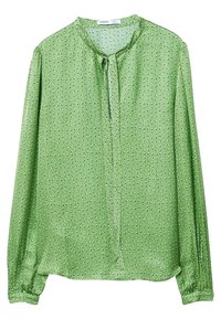 Blusa verde realizzata in tessuto morbido con scollo rotondo, maniche lunghe e chiusura con fiocco frontale. Presenta piccoli pois bianchi su tutta la superficie.