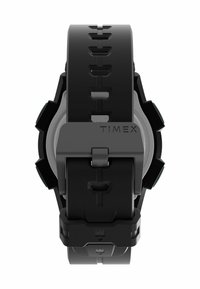 Black rubber watch with a textured strap, featuring a silver round case, side buttons, and a black clasp with the Timex logo.