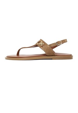 Brown suede flat sandal with toe post, adjustable ankle strap with buckle, and gold metal decorative detail on the upper strap.