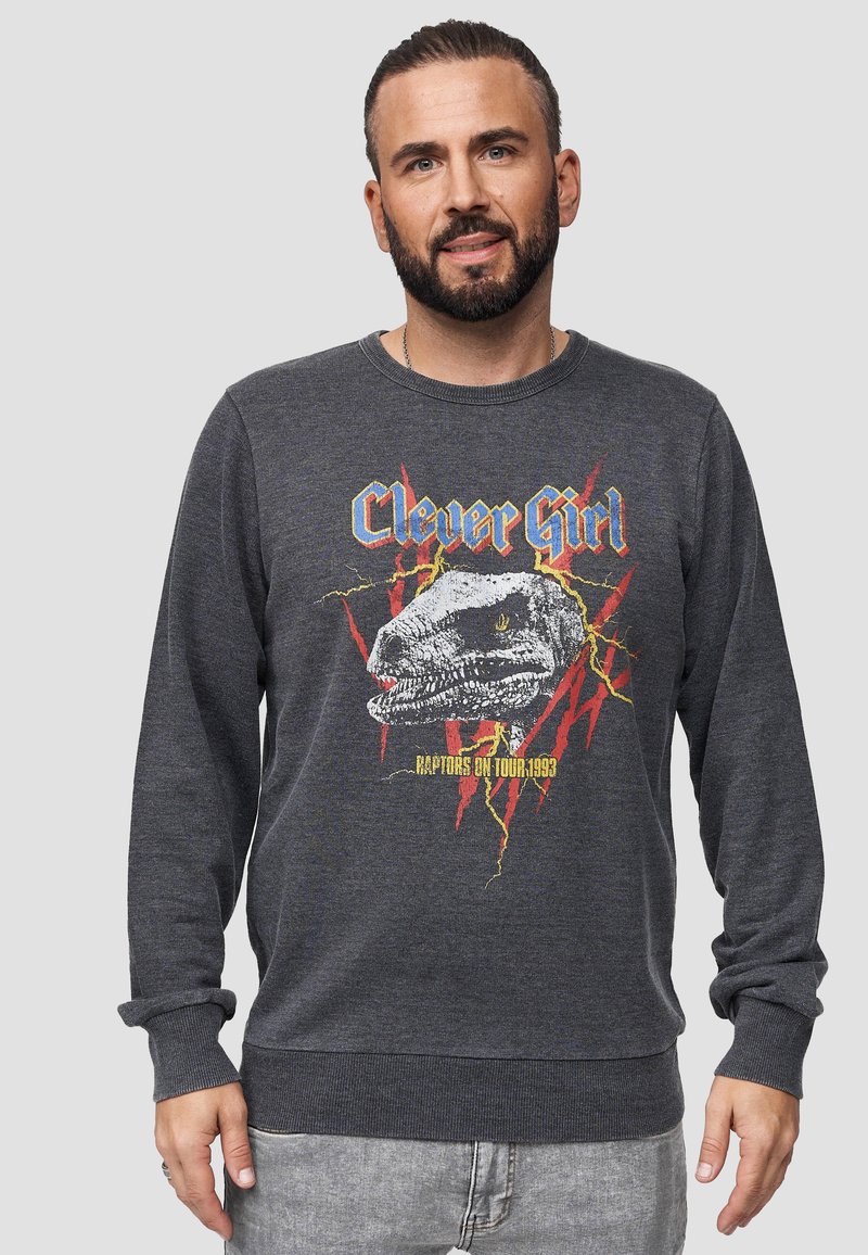 Felpa grigia in misto cotone, con una grafica di dinosauro e testo "Clever Girl" accompagnato da un design di fulmini rossi, polsini e scollo a costine.