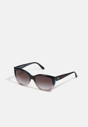 Sonnenbrille mit übergroßen rechteckigen Rahmen, die von Dunkelblau zu Pink übergeht. Glattes Plastikmaterial mit gradienten getönten Gläsern. Goldenes Logo-Detail.
